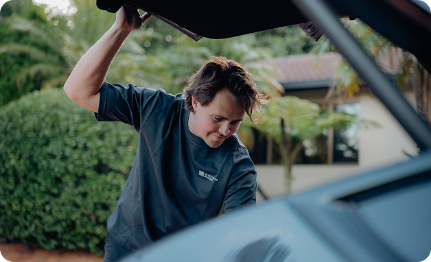 Man opening car trunk